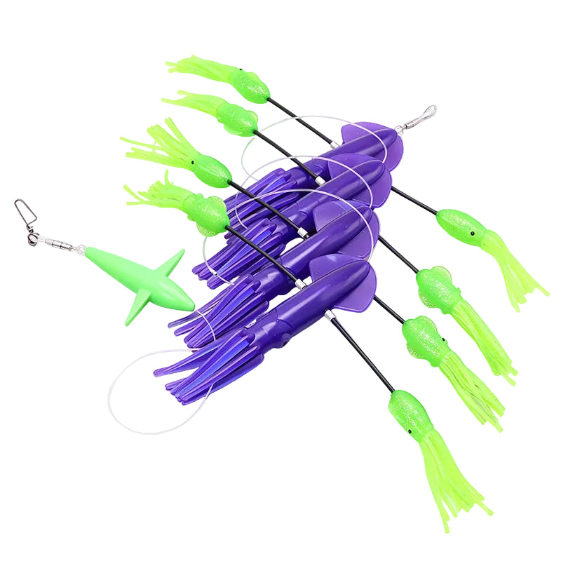 An offshore pelagic fishing teaser on a white background, featuring purple squid with bright green flippy floppies and a separate green bird-shaped tail rigged on mono, all with a snap swivel on the end to attach a ballyhoo or chugger.